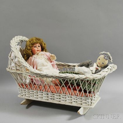 Two Dolls and a White Wicker Cradle