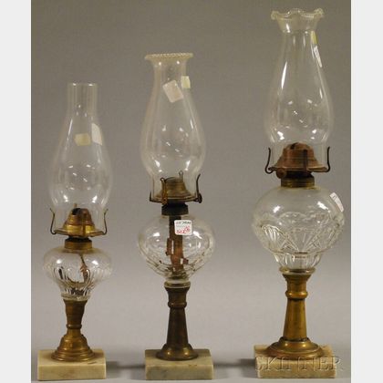 Three Pressed Colorless Glass, Brass, and Marble Kerosene Table Lamps
