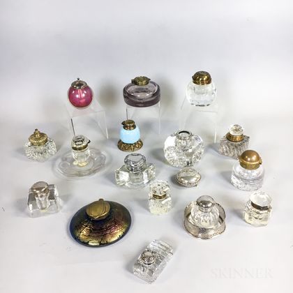 Sixteen Metal-mounted Glass Inkwells and Ink Stands