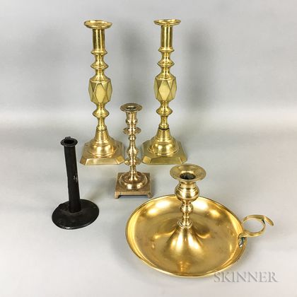 Four Brass and Iron Candlesticks and a Brass Chamberstick