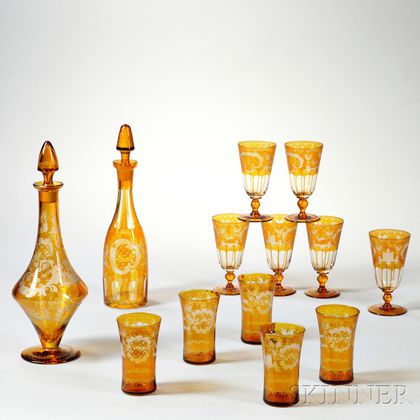 Two Bohemian Amber Etched Glass Decanters and Eleven Glasses