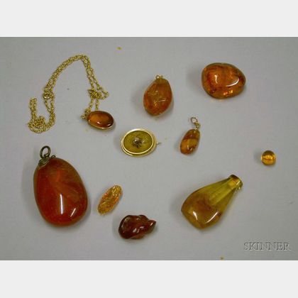 Four Amber Pendants, and Spider Trapped in Amber Pin, an Amber Perfume, and Three Loose Amber Pieces. 
