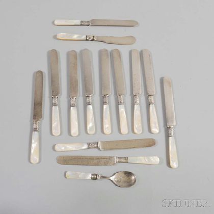 Thirteen Mother-of-pearl-handled Luncheon Knives and a Spoon. Estimate $40-50
