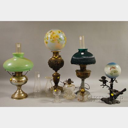 Six Assorted Oil and Kerosene Table Lamps and a Patinated Cast Metal Bird Figural Table Lamp