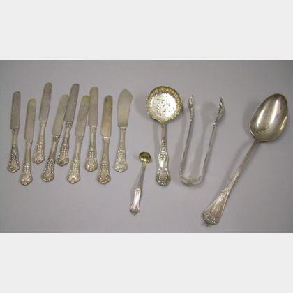 Nine Tiffany & Co. Silver Plated Knives, a Serving Spoon, Small Ladle, Serving Tongs, and a Stuffing Spoon