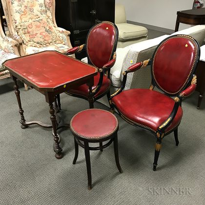 Pair of Leather-upholstered Fauteuil, a Table, and a Stool. Estimate $300-500