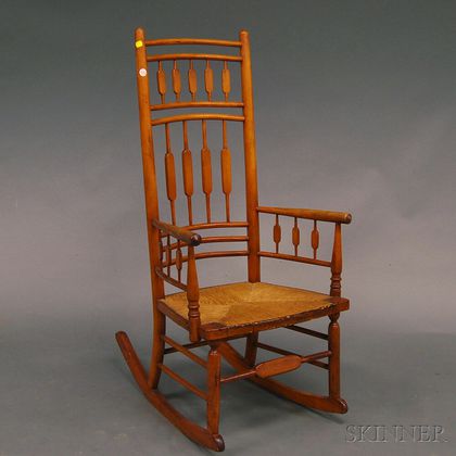 William White Maple Arrow-back Windsor Armed Rocker and a Southwest Caucasian Rug