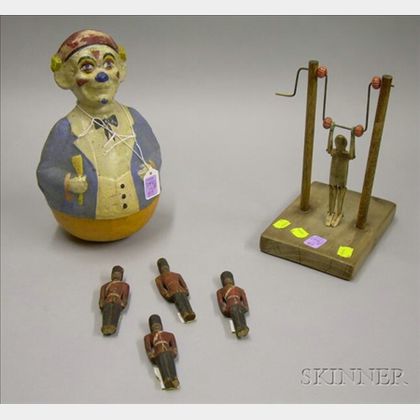 Painted Composition Roly Poly Clown, a Folk Carved Bone Acrobat Toy, and Four Small Carved and Painted Wooden S... 
