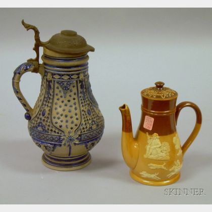 German Cobalt Highlighted Stoneware Flagon and a Doulton Lambeth Glazed Stoneware Teapot. 