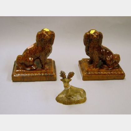 Small Painted Chalkware Recumbent Stag and a Pair of Glazed Redware Spaniels