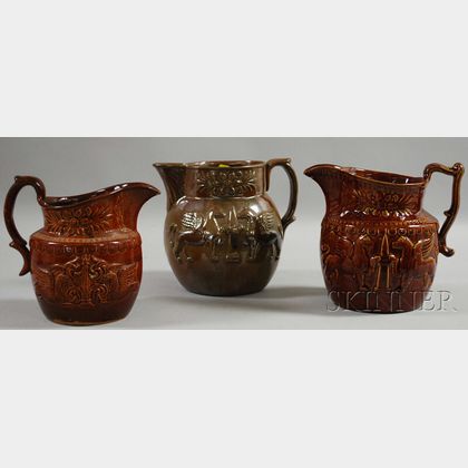 Three Bennington and Rockingham Glazed Molded Pottery Pitchers with Griffin Decoration