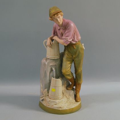 Painted Porcelain Figural Group of a Young Boy Standing at a Water Pump
