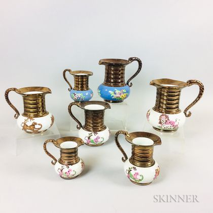 Seven Copper Lustre Ceramic Jugs
