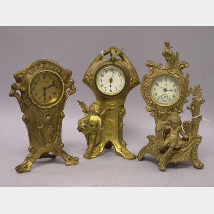 Three Rococo-style and Art Nouveau Gilt Cast Metal Figural Timepieces