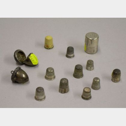 Nine Sterling and Coin Silver Thimbles, Two Acorn-form Thimble Cases, and a Spool Thread Case. 