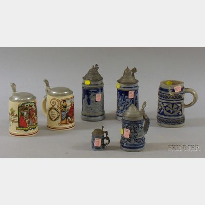 Five German Cobalt Highlighted Molded Stoneware Steins and a Pair of German PUG Stoneware Steins