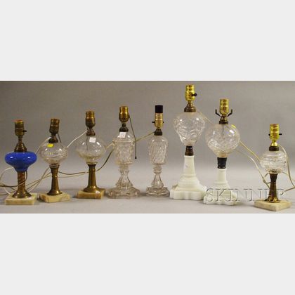 Eight Mostly Colorless Molded Glass Fluid and Kerosene Oil Table Lamps