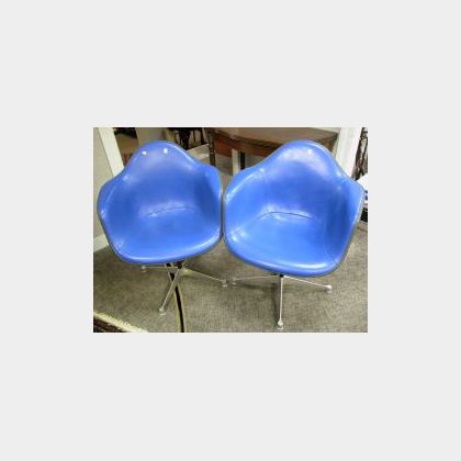 Pair of Eames Blue Upholstered Swivel Armchairs. 