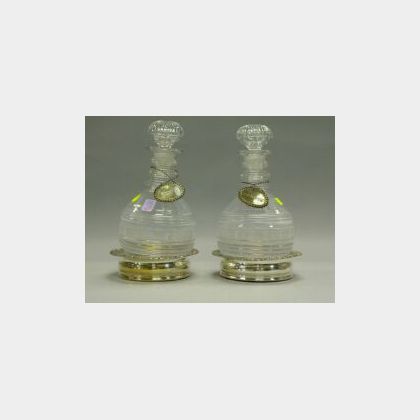Pair of Colorless Cut Glass Decanters with Silver Plated Tags and Wine Coasters. 