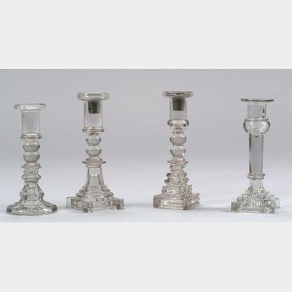 Four Colorless Pressed and Blown Glass Candlesticks