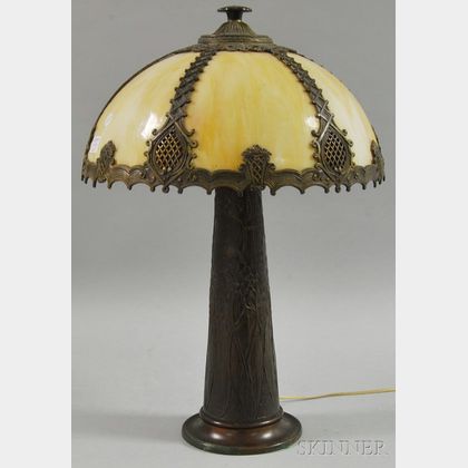 Metal Overlay Caramel Slag Glass Bent Panel Lamp Shade and Patinated Cast Metal Floral-decorated Lamp Base