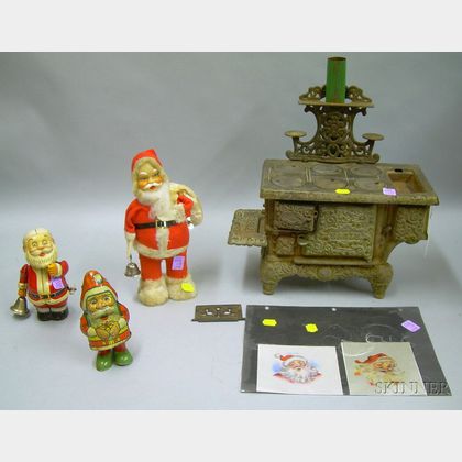 Toy Cast Iron "Eagle" Stove, Three Wind-up Santa Figures, and Two Printed Portraits of Santa on Silk