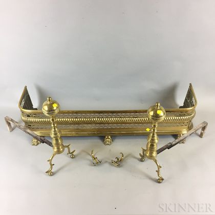 Pair of Brass Belted Ball-top Andirons and a Pierced Brass Fender