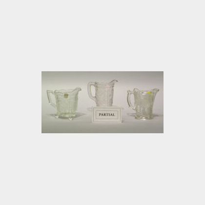 Twenty-one Victorian Colorless Pattern Glass Pitchers. 