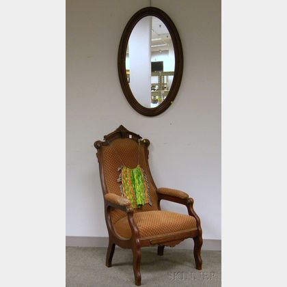 Victorian Renaissance Revival Upholstered Carved Walnut Armchair and an Oval Walnut Mirror