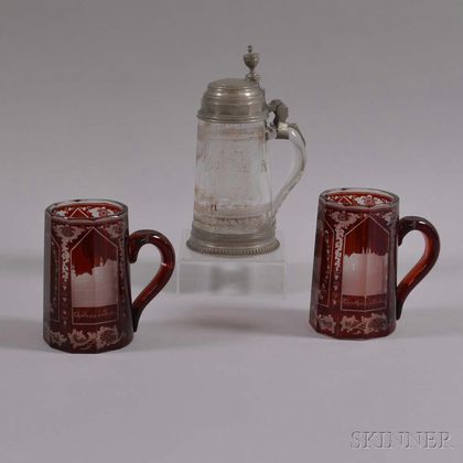 One Colorless and Two Etched Cranberry Glass Steins