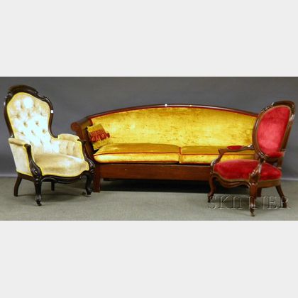 Two Victorian Rococo Revival Upholstered Carved Walnut Parlor Armchairs and an Early 20th Century Upholstered Walnut Spindle-sided Sofa