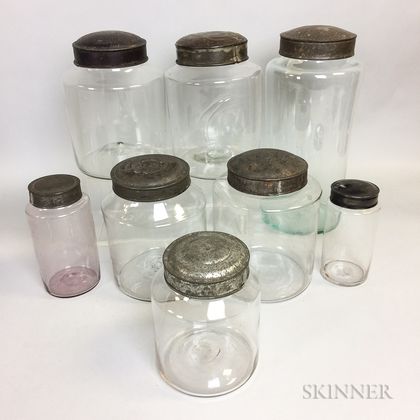 Eight Colorless Glass Covered Jars