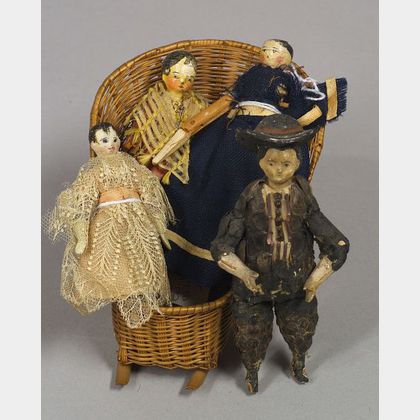 Four Early Wooden Dolls and a Woven Basket Chair