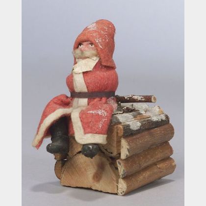 Small Papier-mache Santa Sitting on a Log