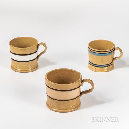 Three Slip-decorated Yellowware Mugs
