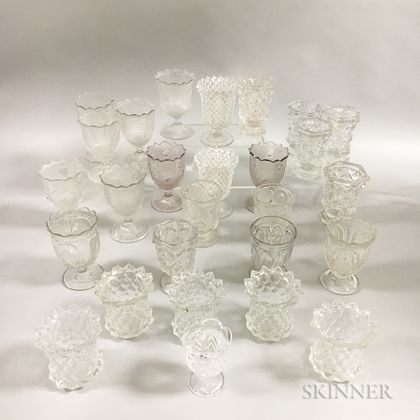 Twenty-seven Colorless Pressed Glass Spoon and Spill Holders. Estimate $200-300