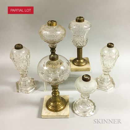 Seventeen Colorless Pressed Glass Fluid Lamps. Estimate $200-300