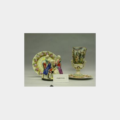 Pair of Bisque Figures, Porcelain Figural Group, Pair of Vienna-style Plates and a Capo-di-Monte Mantel Urn. 