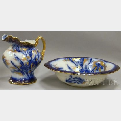 English Art Nouveau Gilt and Flow Blue Iris-decorated Ceramic Chamber Pitcher and Basin. Estimate $200-300