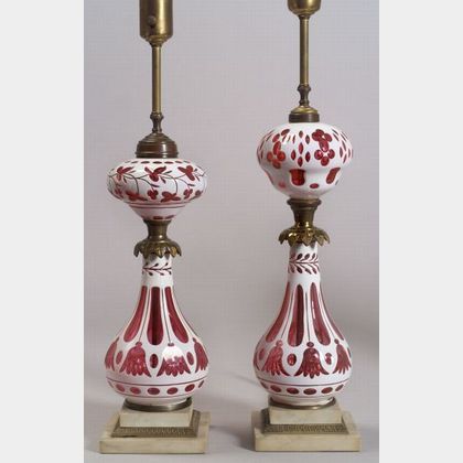 Two Similar White Cased Cut-to-Cranberry Glass Oil Lamps