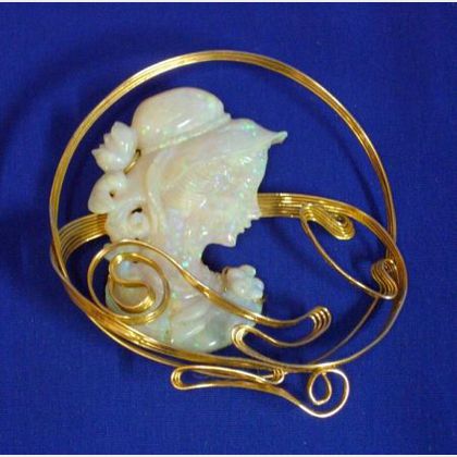 Large Carved Opal and Undulating Gold Framed Pendant/Brooch. 