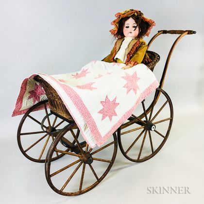 German Bisque Socket Head Doll, Wicker Doll Carriage, and an Appliqued Cotton Doll Quilt. Estimate $200-300
