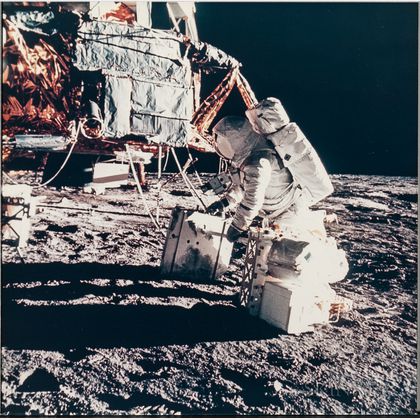 Apollo 12, Astronaut Alan L. Bean Unloads Apollo Lunar Surface Experiment Package (ALSEP) Radioisotope Thermoelectric Generator (... 