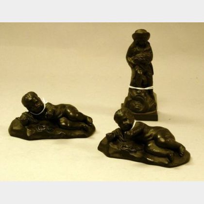 Wedgwood Black Basalt Figure and a Pair of Black Basalt Figures of a Reclining Baby Boy. 