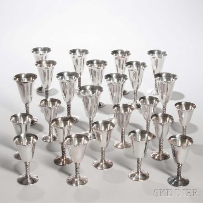 Twenty-four Spanish Silver-plated Wineglasses, each with a grapevine motif to stem, ht. 5 1/2, 7 in.Provenance: The Estate of Elaine Sa