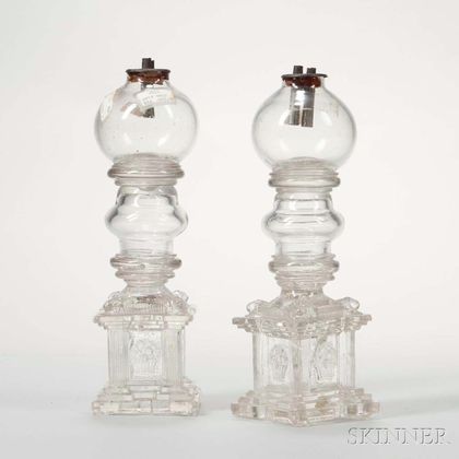 Pair of Colorless Free-blown Globe Lamps with Pressed Glass Lion Head and Basket of Flowers Bases