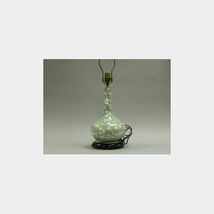 Celadon Porcelain Bottle-form Vase, China, late 19th century, pale green ground with white pate-sur-pate decorated foliage, ht. 12 in.;