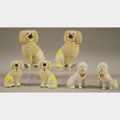 Three Pairs of Staffordshire and Porcelain Seated Spaniel Figures
