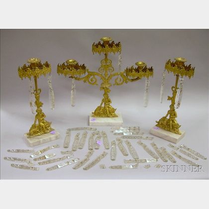 Three-piece Gilt Brass Figural Girandole Set with Prisms. 