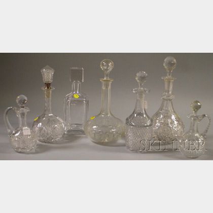Four Colorless Cut Glass Decanters, Two Cruets, and a Kosta Boda Crystal Decanter. 